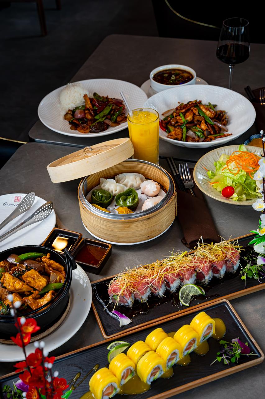 Table spread at Cherry Amber with dim sum, wok-fired entrees and sushi rolls