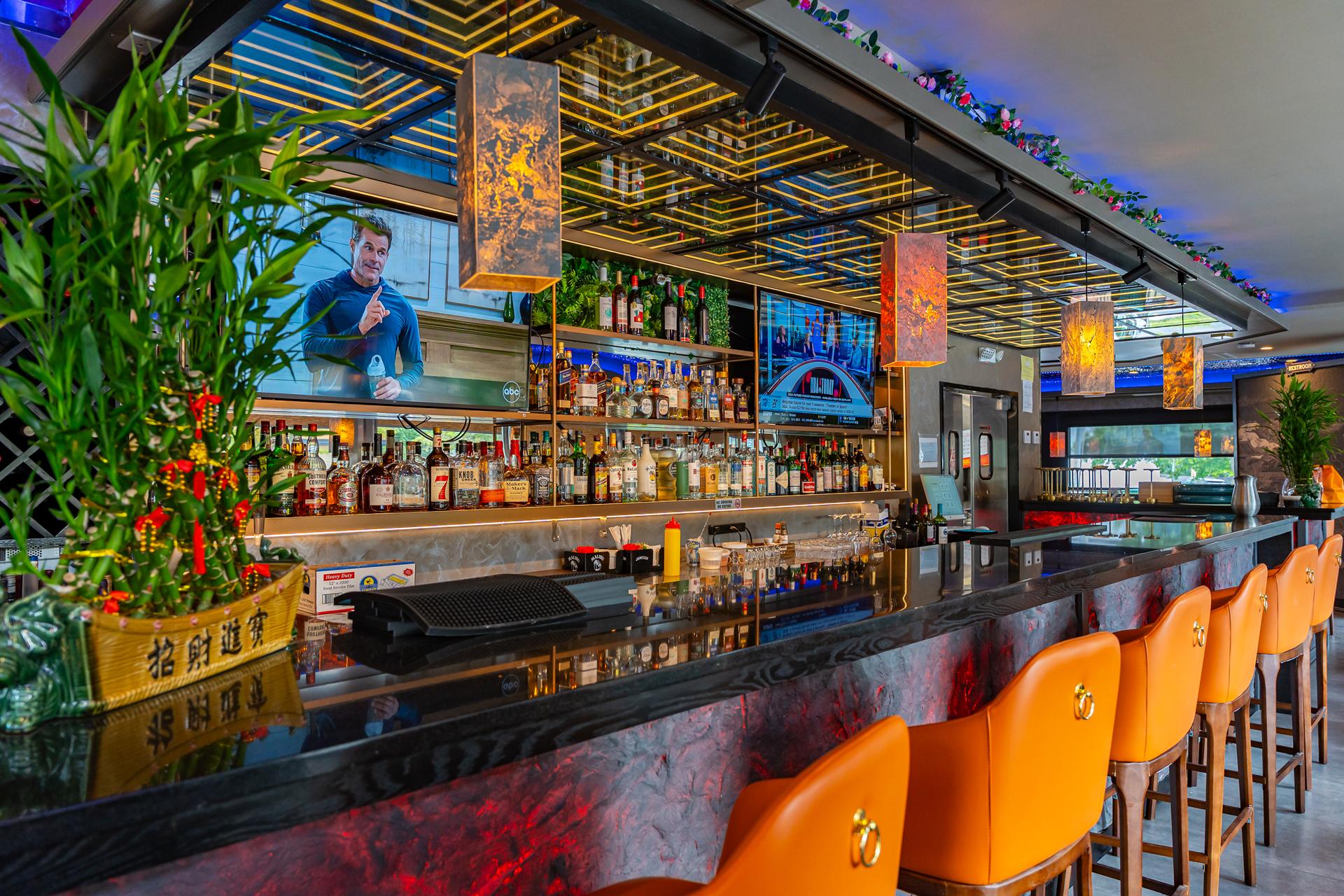 Cherry Amber cocktail bar and lounge with orange bar stools