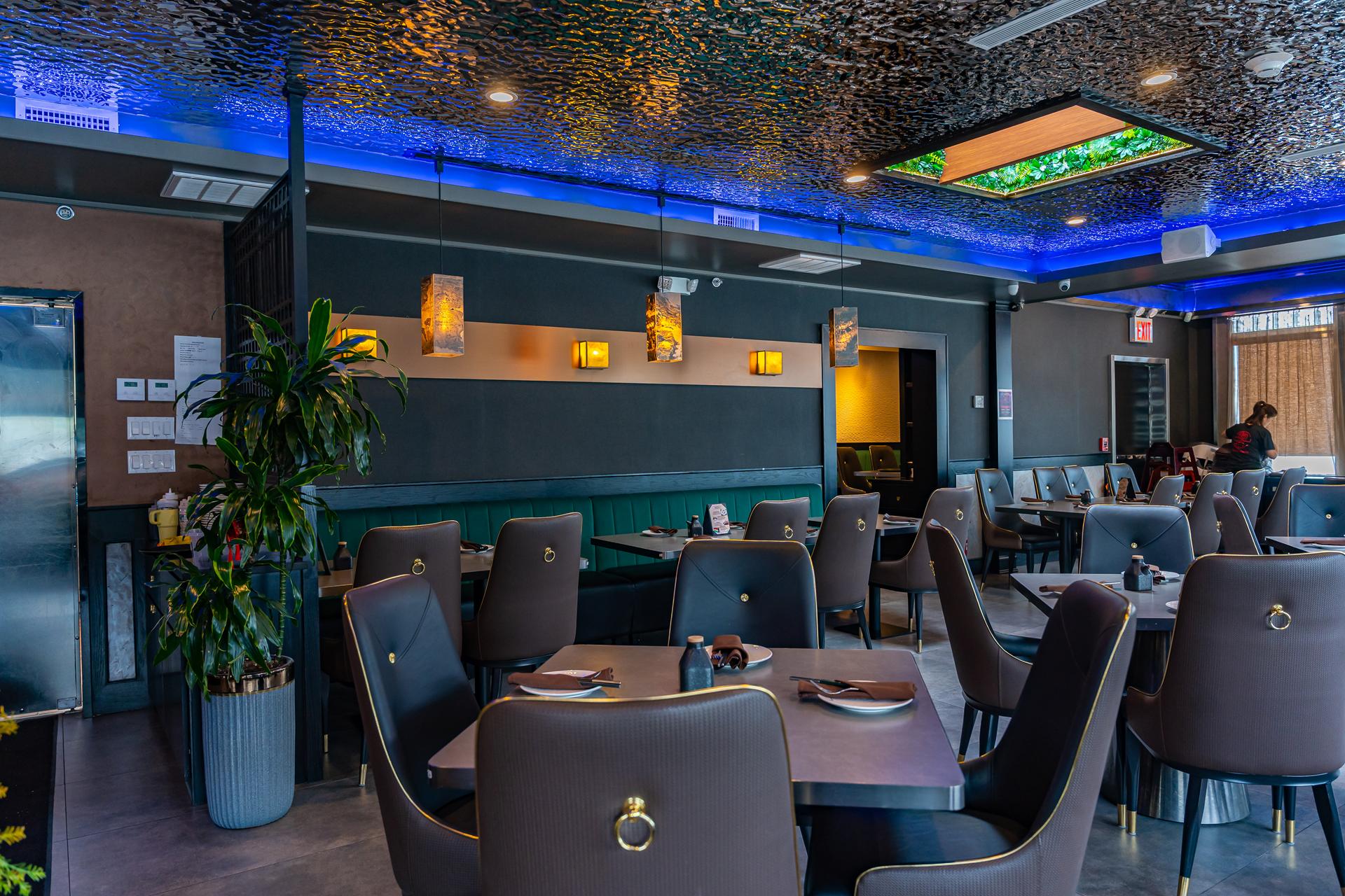 Cherry Amber dining room with teal booths and blue ceiling lighting